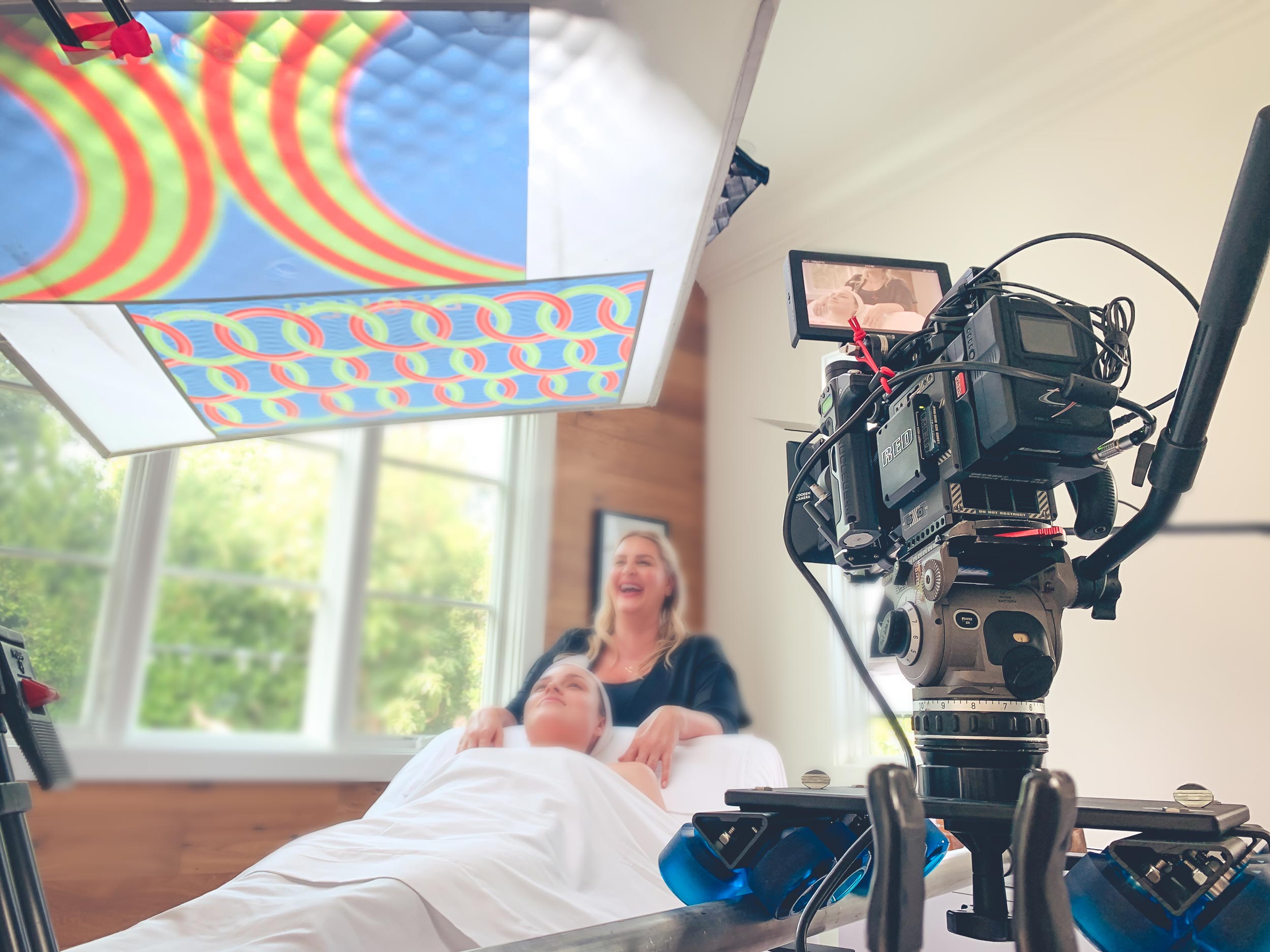 Cinema camera on set for a beauty production, subject on treatment bed